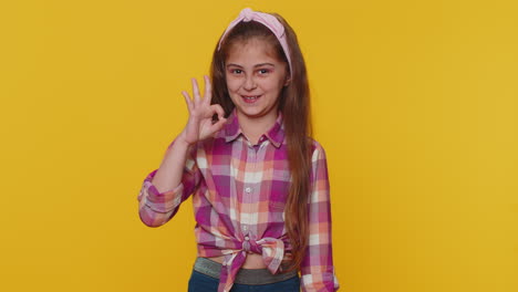 Happy-cheerful-child-girl-kid-looking-approvingly-at-camera-showing-ok-gesture,-positive-like-sign