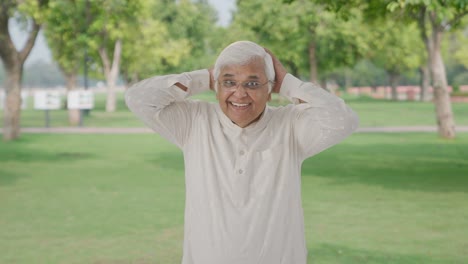 Happy-Indian-old-man-getting-ready-to-go-out-in-park