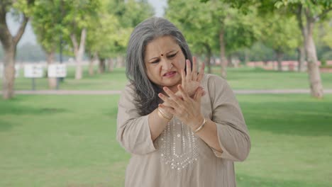 Sick-Indian-old-woman-suffering-from-arthritis-in-park