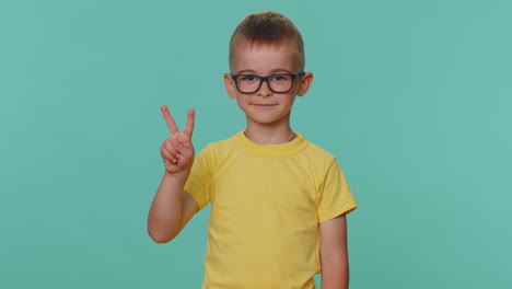 Happy-smiling-toddler-children-boy-showing-victory-sign,-hoping-for-success-win,-doing-peace-gesture