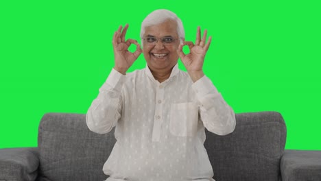 Happy-Indian-old-man-showing-okay-sign-Green-screen