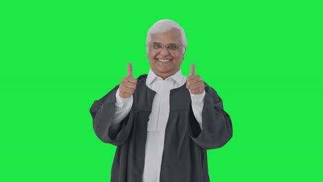 Happy-Indian-senior-lawyer-showing-thumbs-up-Green-screen