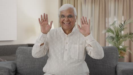 Happy-Indian-old-man-waving-hand-and-saying-hello