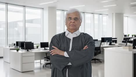 Indian-senior-lawyer-standing-crossed-hands