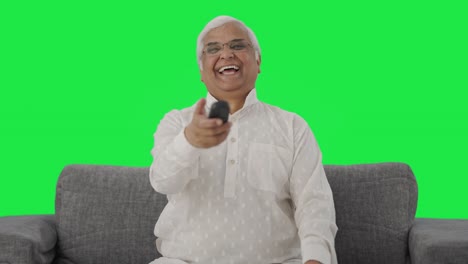 Happy-Indian-old-man-watching-TV-and-laughing-Green-screen