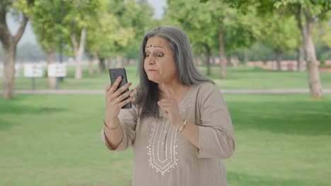 Angry-Indian-old-woman-shouting-on-video-call-in-park