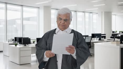 Indian-senior-lawyer-reading-court-case-papers