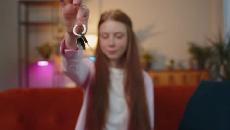 Child-girl-real-estate-agent-showing-the-keys-of-new-home-house-apartment-buying-or-renting-property