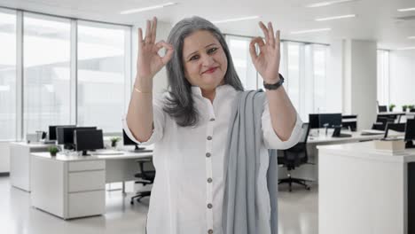 Happy-Indian-senior-businesswoman-showing-okay-sign