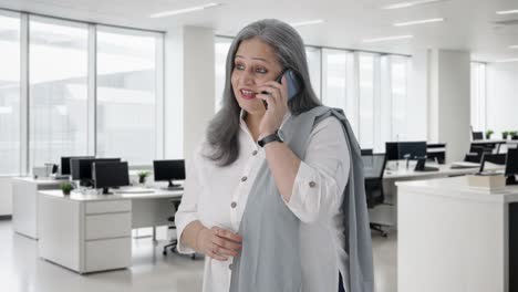 Happy-Indian-senior-businesswoman-talking-on-call