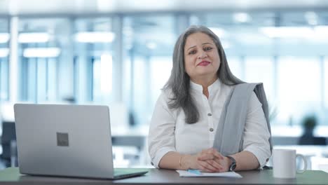 Happy-Indian-senior-businesswoman-smiling-to-the-camera