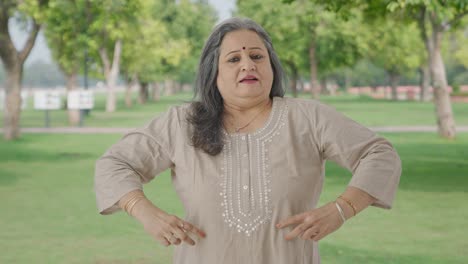 Happy-Indian-old-woman-getting-ready-to-go-out-in-park