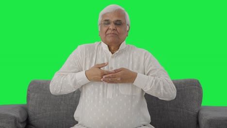 Happy-Indian-old-man-doing-breathe-in-breathe-out-exercise-Green-screen