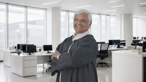 Portrait-of-Happy-Indian-senior-lawyer-standing-crossed-hands