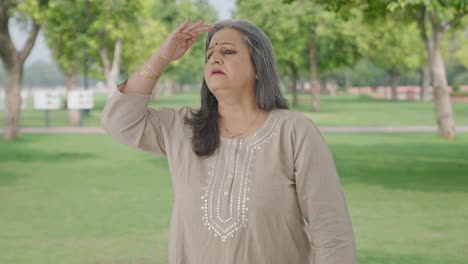 Confused-Indian-old-woman-looking-for-someone-in-park