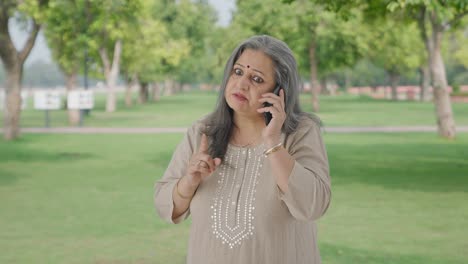 Angry-Indian-old-woman-shouting-on-call-in-park