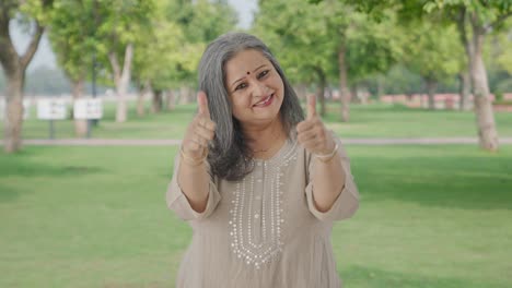 Happy-Indian-old-woman-showing-thumbs-up-in-park