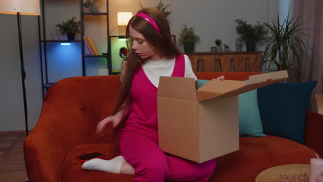 Angry-dissatisfied-shopper-child-girl-kid-unpacking-parcel-feeling-upset,-confused,-wrong-delivery