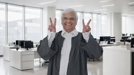 Happy-Indian-senior-lawyer-showing-victory-sign