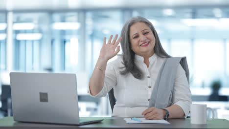 Happy-Indian-senior-businesswoman-waving-and-saying-Hello