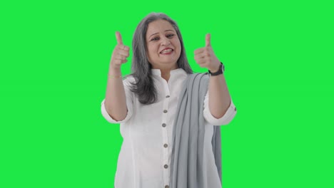 Happy-Indian-senior-businesswoman-showing-thumbs-up-Green-screen