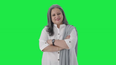 Happy-Indian-senior-businesswoman-standing-crossed-hands-Green-screen