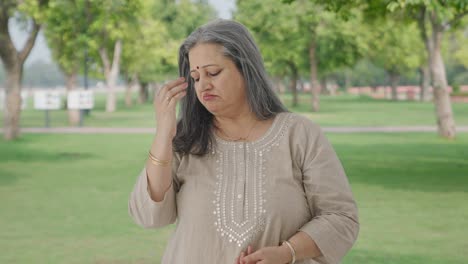 Sick-Indian-old-woman-suffering-from-hairfall-in-park