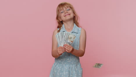 Money-cash-dollar-rain-falling-on-child-girl-kid-celebrating-success,-winning-lottery-jackpot-luck