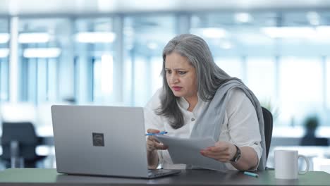 Angry-Indian-senior-female-manager-doing-meeting-on-video-call