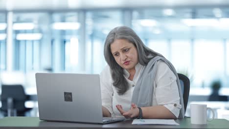 Indian-senior-female-manager-doing-meeting-on-video-call