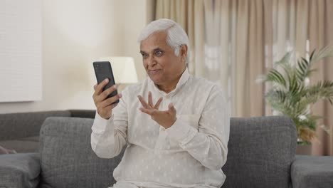 Happy-Indian-old-man-talking-on-video-call