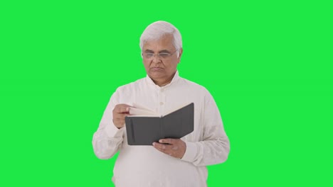 Confused-Indian-old-man-reading-a-book-Green-screen