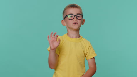 Happy-toddler-children-boy-smiling-friendly-at-camera-and-waving-hands-gesturing-hello-or-goodbye