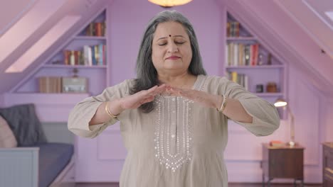 Happy-Indian-old-woman-doing-breathe-in-breathe-out-exercise