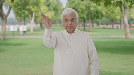 Angry-Indian-old-man-shouting-on-someone-in-park