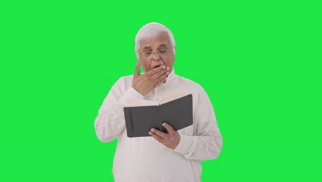 Sleepy-Indian-old-man-reading-a-book-Green-screen