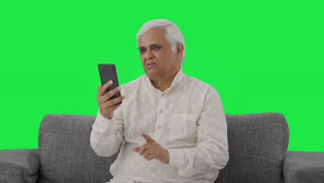 Indian-old-man-talking-on-video-call-Green-screen