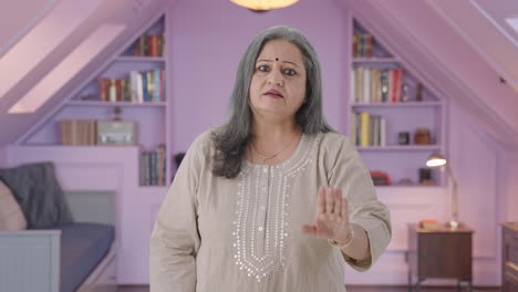 Stressed-Indian-old-woman-shouting-at-someone