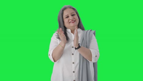 Happy-Indian-senior-businesswoman-clapping-and-appreciating-Green-screen