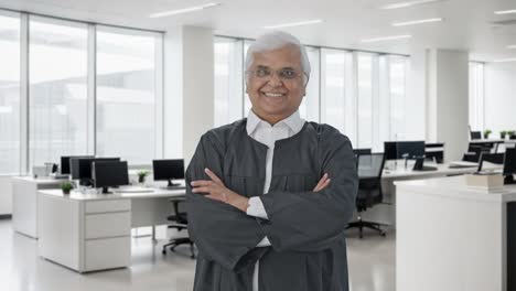 Happy-Indian-senior-lawyer-standing-crossed-hands