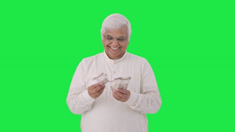 Happy-Indian-old-man-counting-money-Green-screen