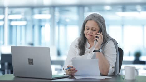 Indian-senior-female-manager-talking-on-phone