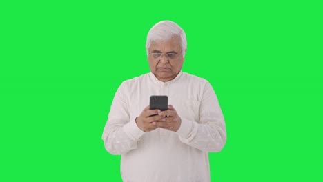 Angry-Indian-old-man-chatting-on-phone-Green-screen