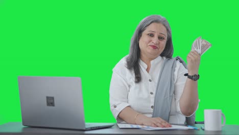 Happy-Indian-senior-businesswoman-using-money-as-fan-Green-screen