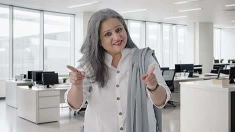 Happy-Indian-senior-businesswoman-talking