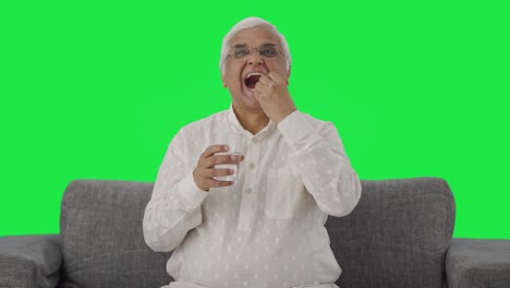 Happy-Indian-old-man-taking-the-medicine-Green-screen