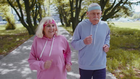 Tired-exhausted-grandfather,-grandmother-relaxing-after-hard-difficult-long-distance-race-in-park