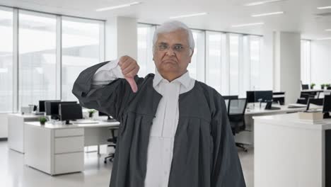 Disappointed-Indian-senior-lawyer-showing-thumbs-down