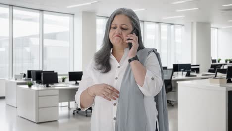 Indian-senior-businesswoman-talking-on-call