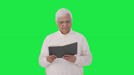 Indian-old-man-reading-a-book-Green-screen